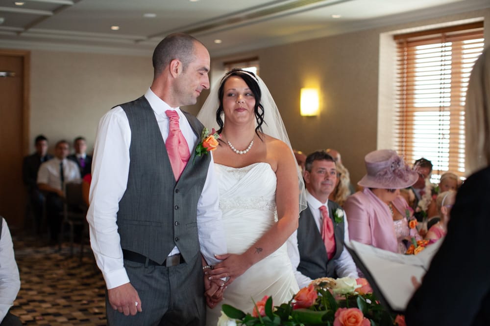 Gemma and Dave share a smile as her father also beams with pride beside them.