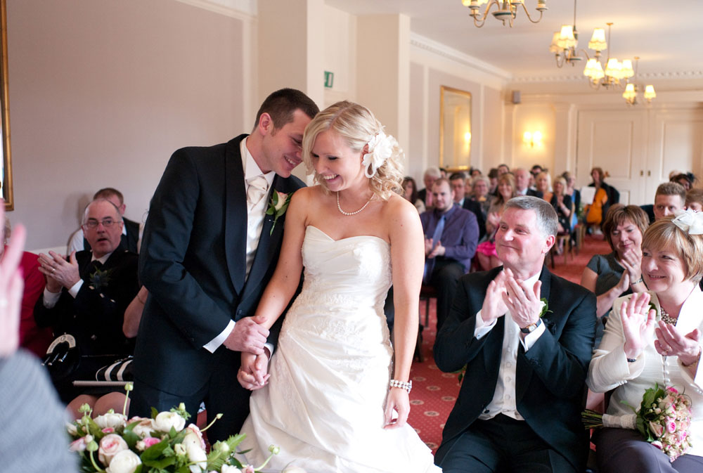 Dani and Scott smile at each other as he whispers