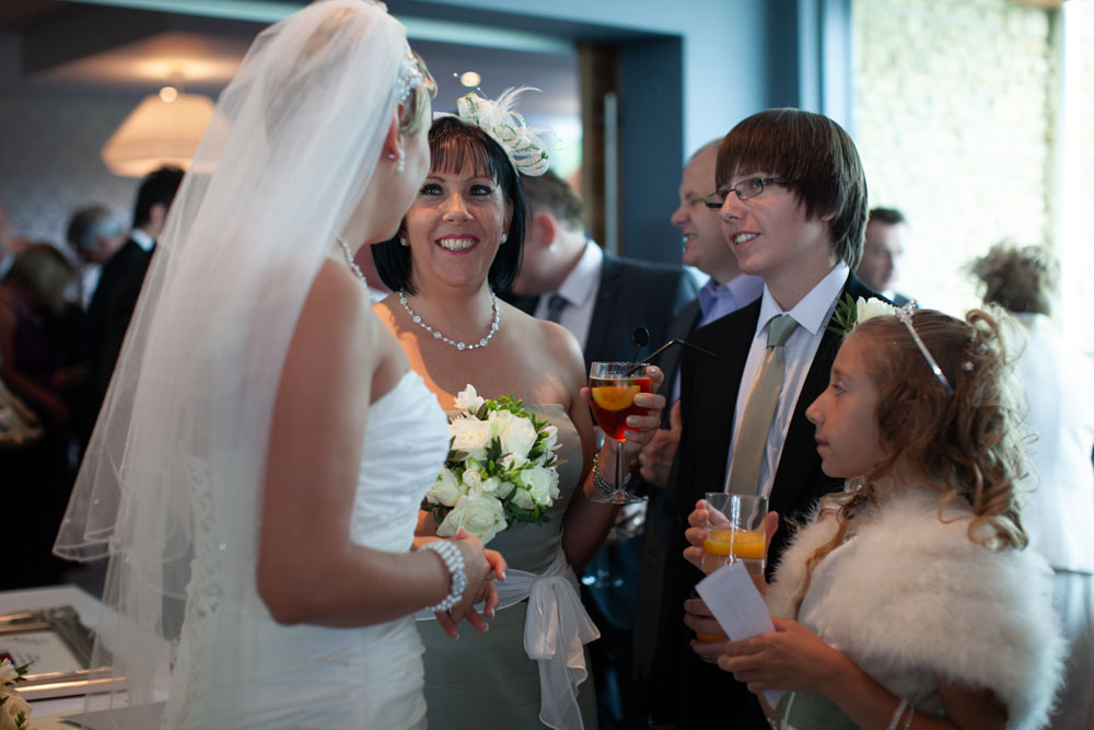More guests gather around Sam as she exits, smiles all around.