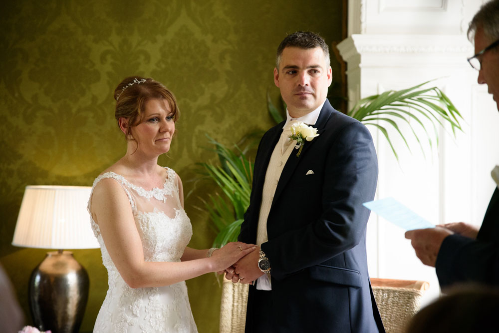 Second reading captures the couple’s full attention during the ceremony.