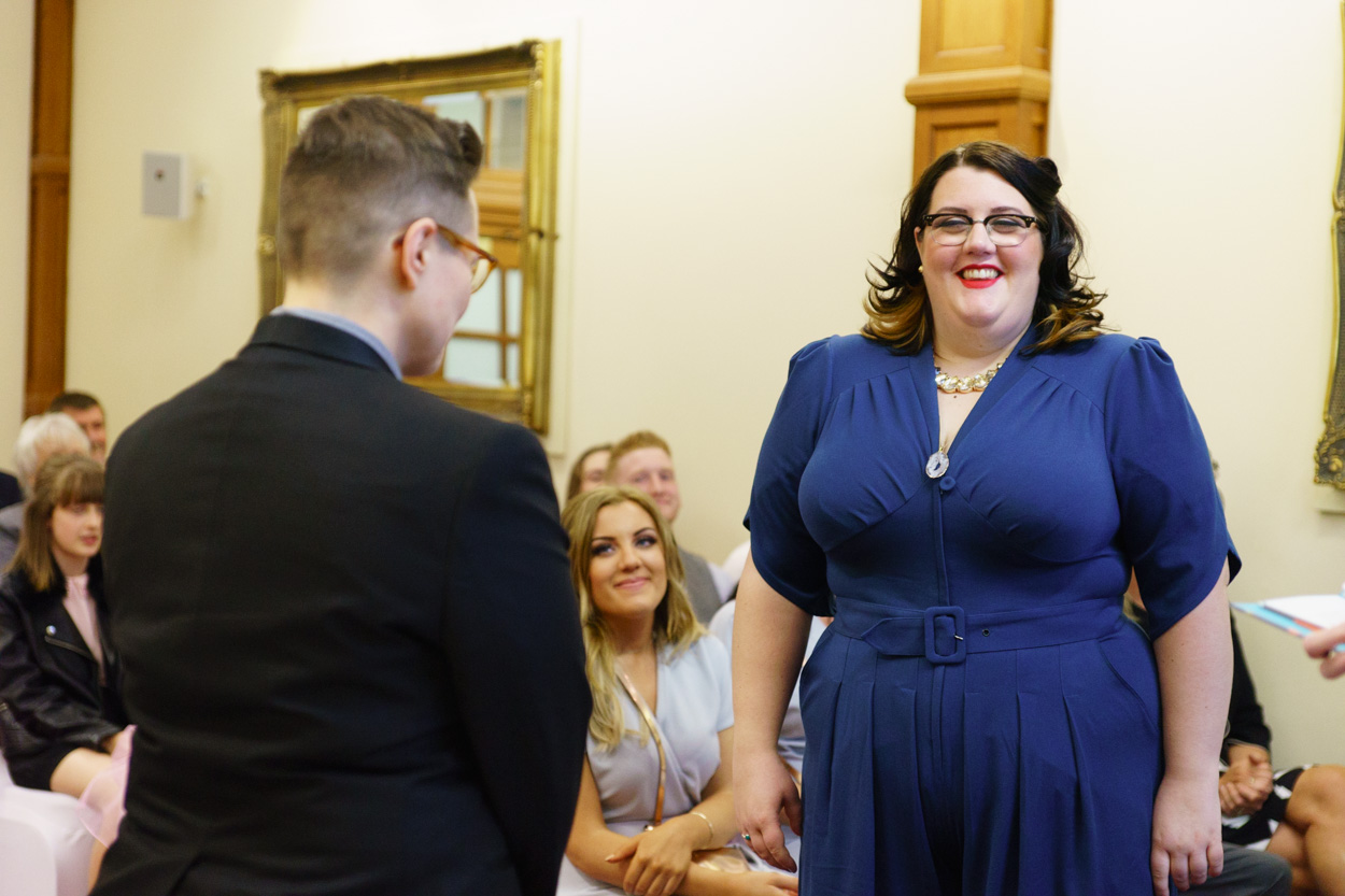 Lizzie and Tamara smiling at each other during the ceremony
