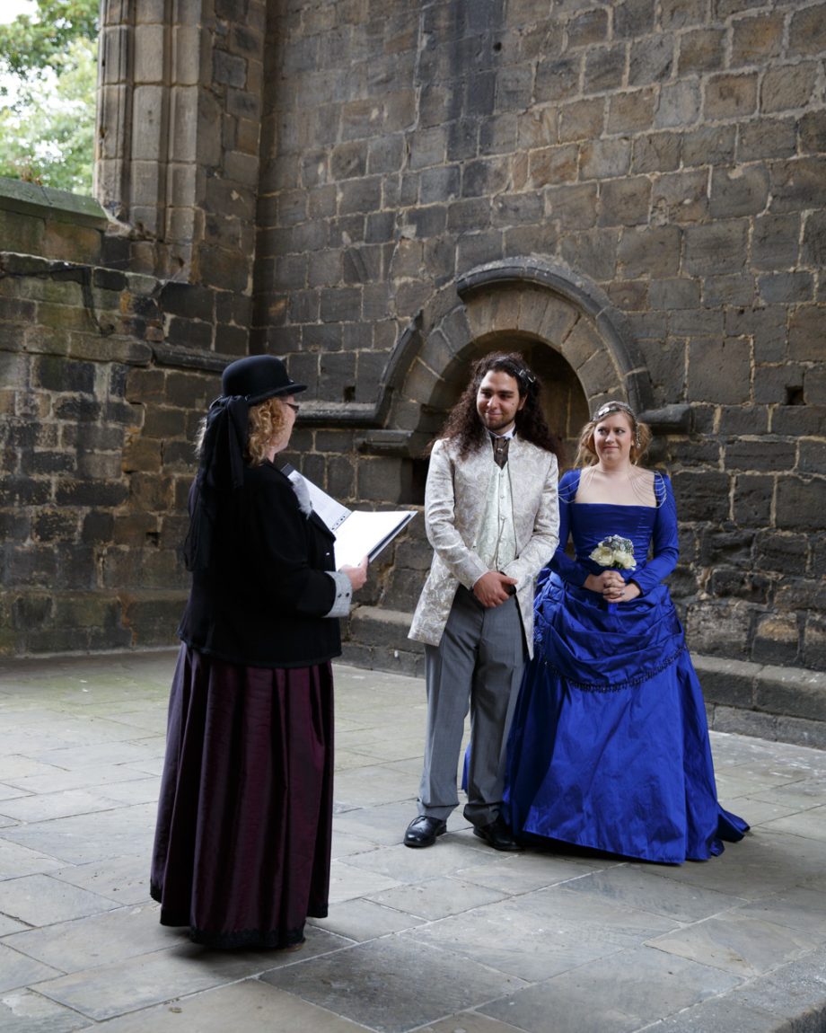 033 The couple listen to the registrar kirkstall abbey wedding linsey and chris