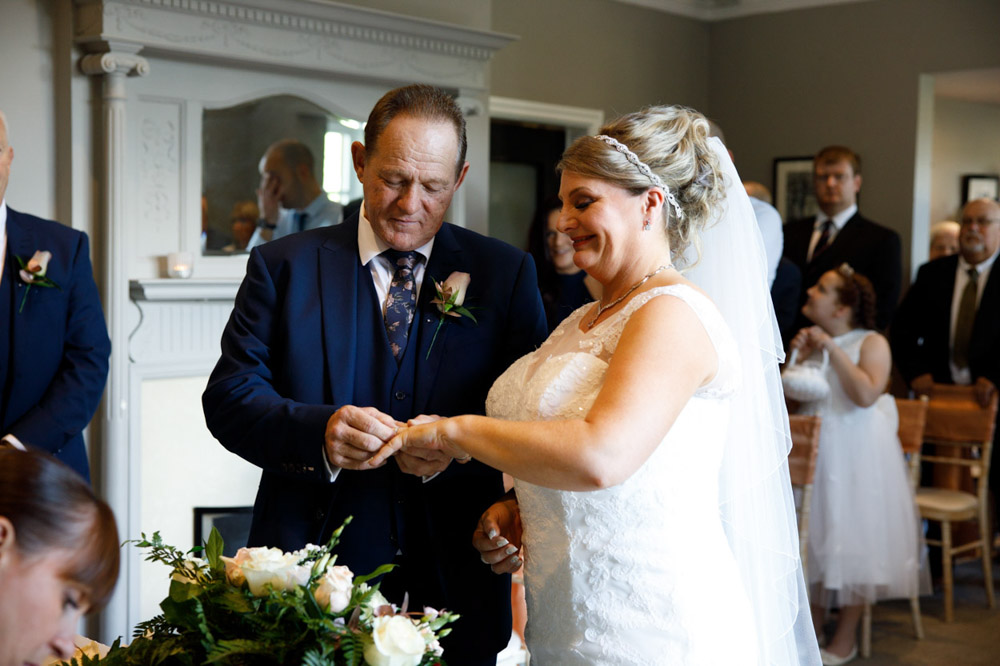 Tracy smiles as the ring is placed on her finger