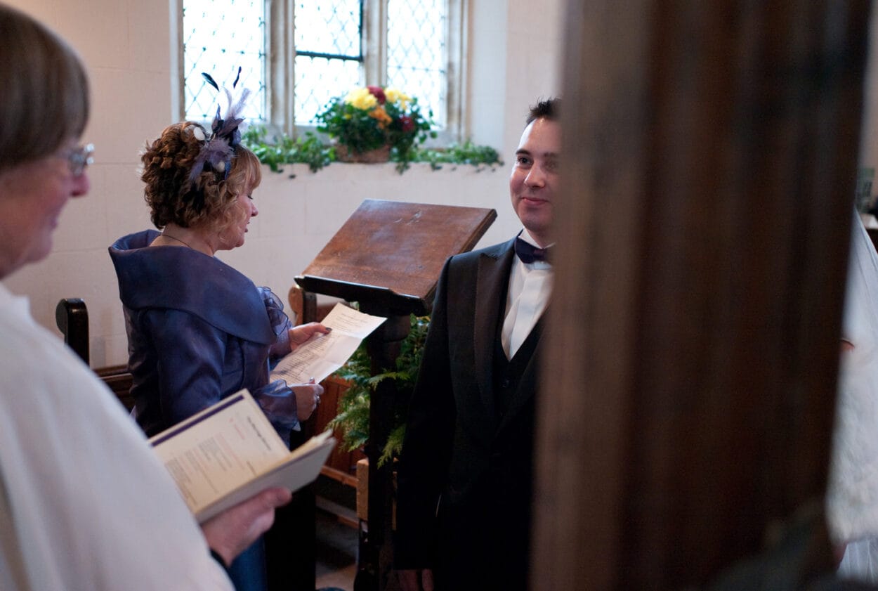 Emelie’s mum reads as the groom smiles softly.