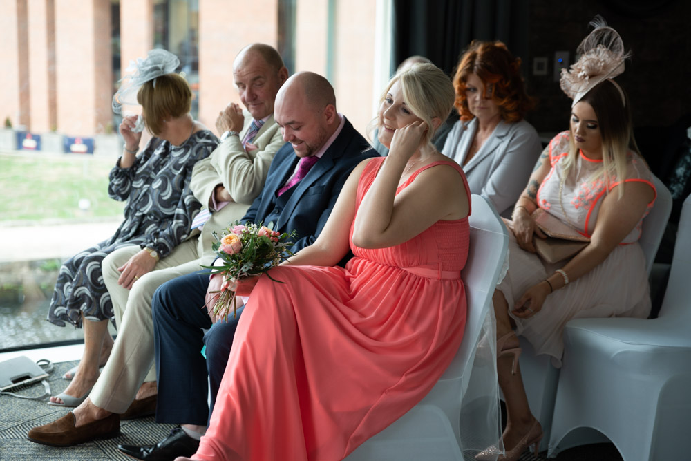 Clare’s daughter smiling sweetly toward the couple