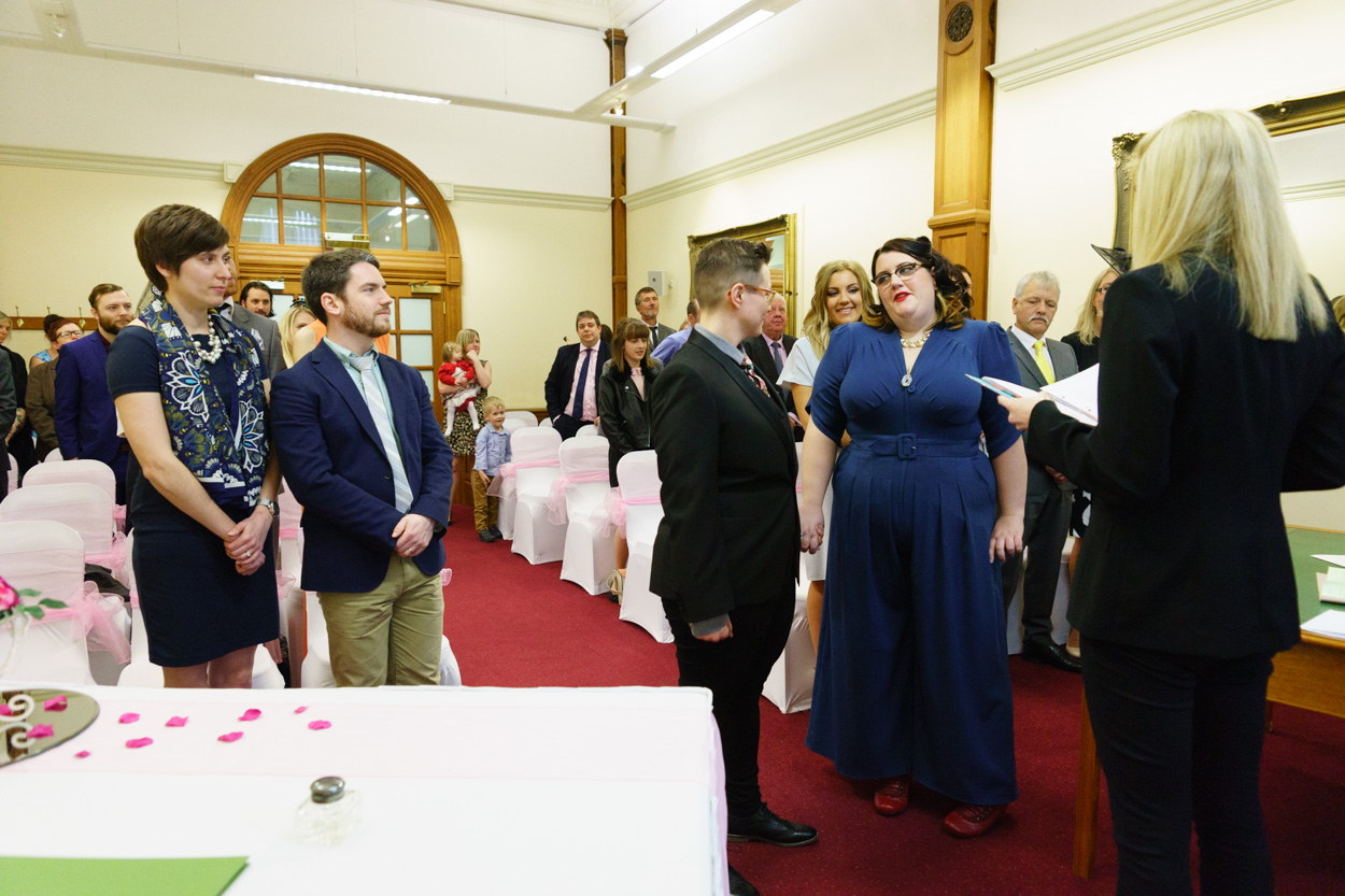 Wide view of the ceremony room as vows begin