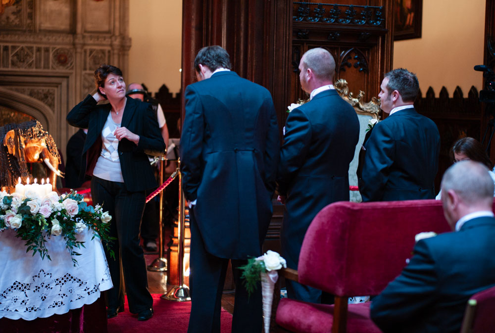 Groom and best men stand beneath the grandeur of Allerton Castle’s ceremony space.