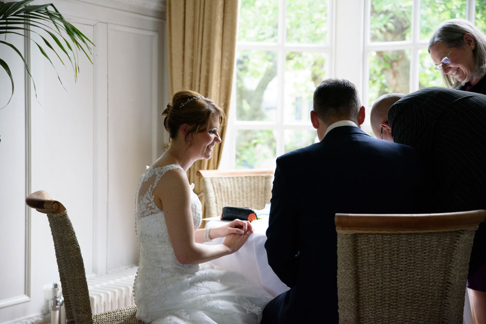 Couple checks the register in the bay window of Grays Court ceremony room.