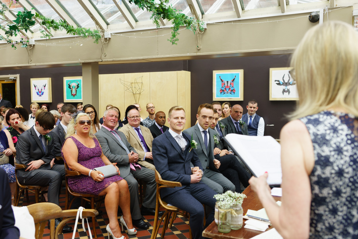 Christian and Jason listening intently during a ceremony reading