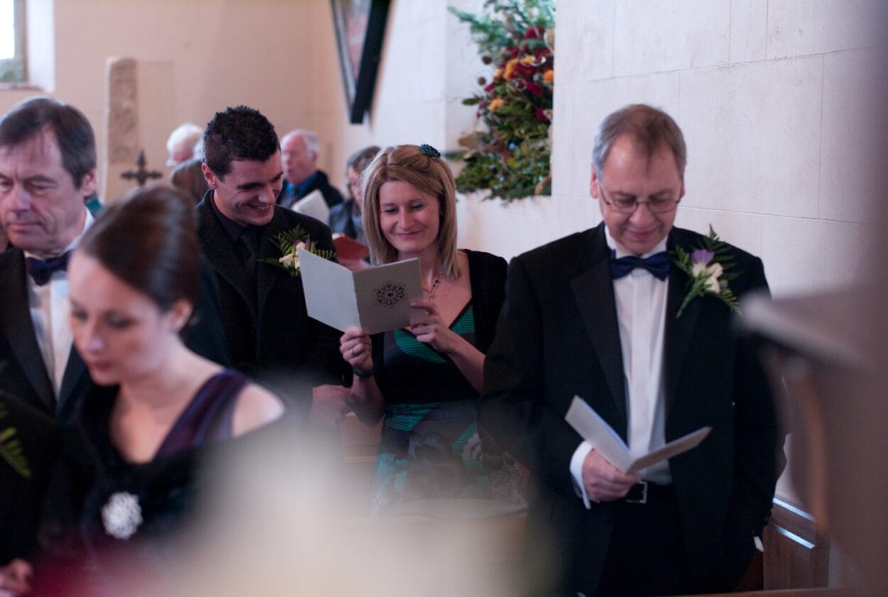 Guests smile widely during the hymns.
