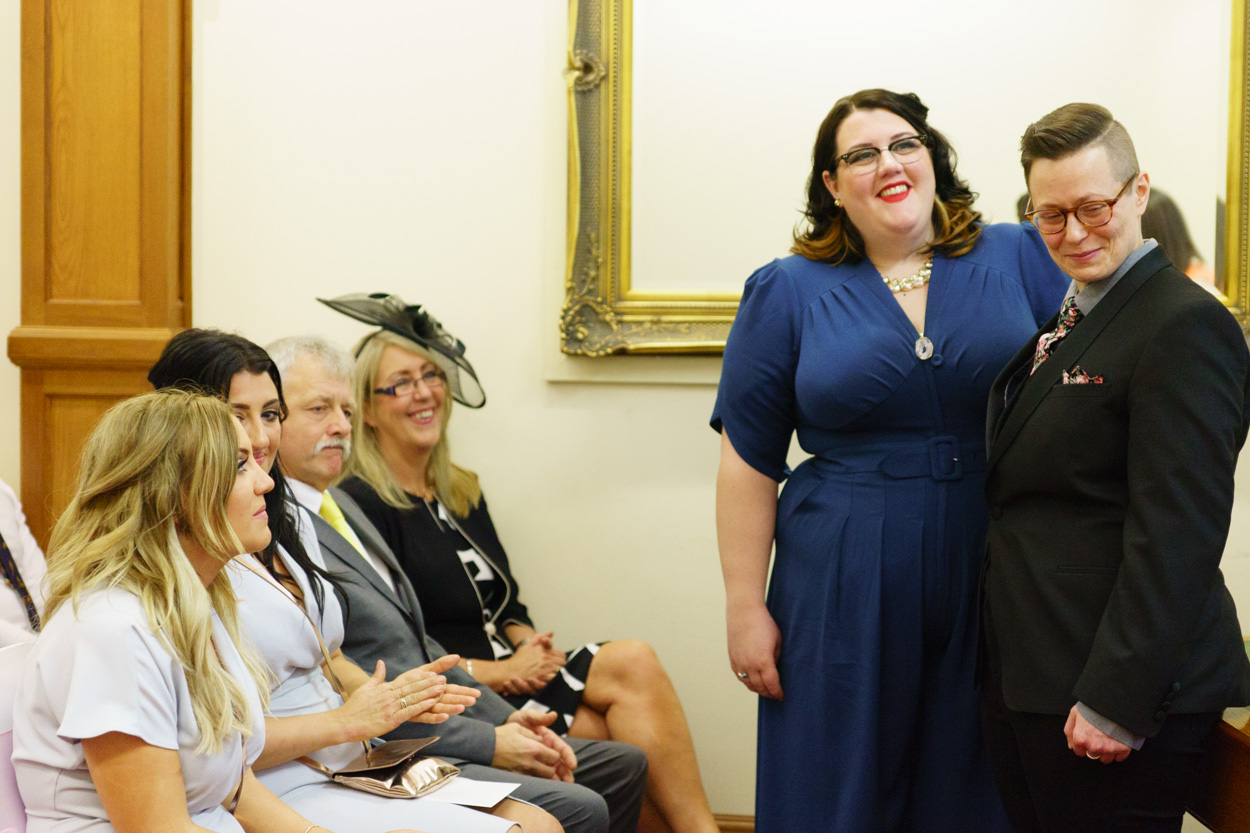 Couple smiling widely as the second reading continues