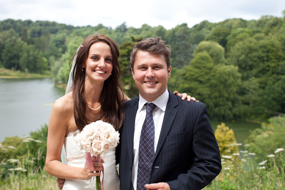 Bride and her brother share a photo outside before the reception