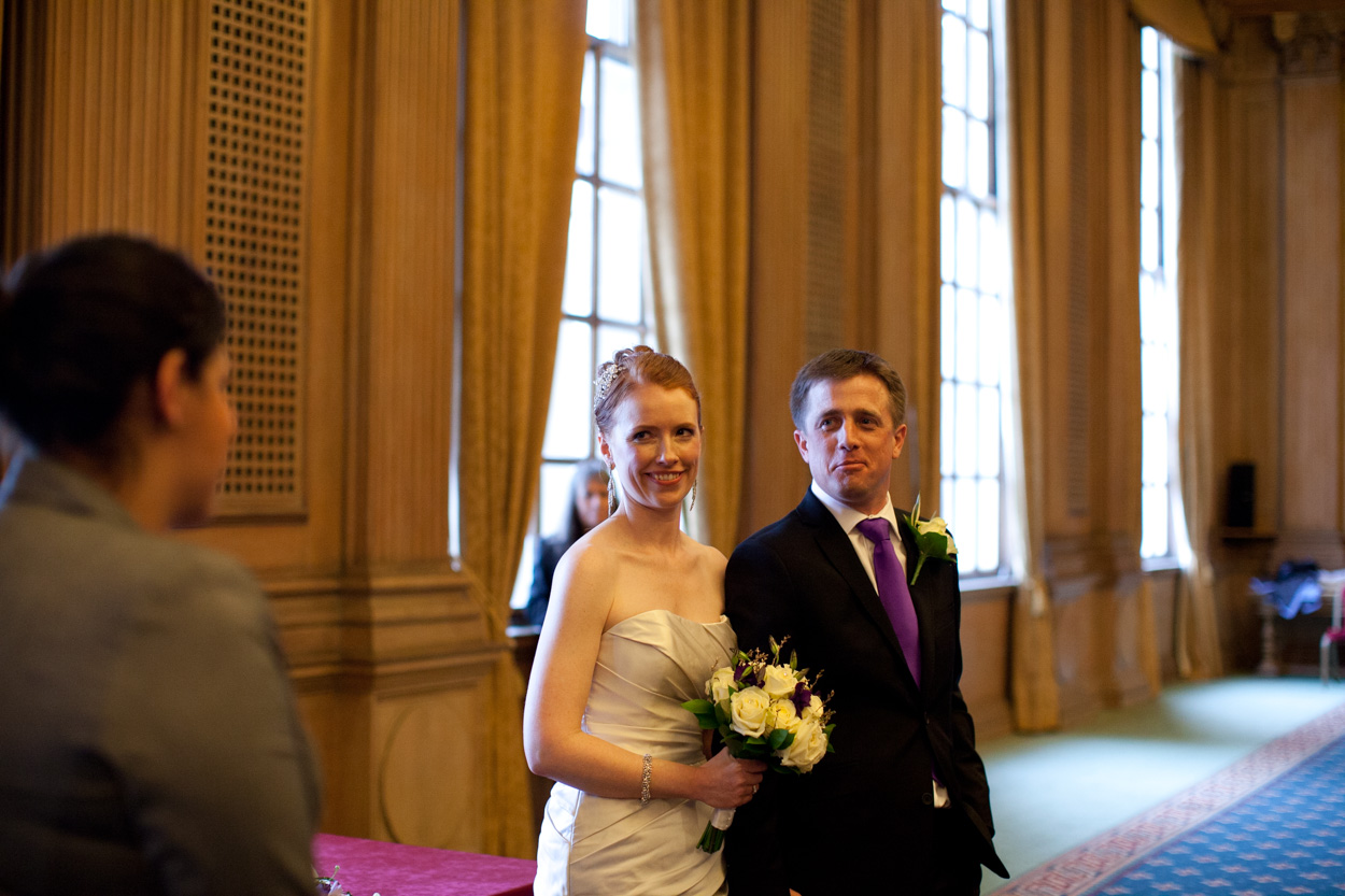 Bride and groom standing together, ready to leave the Banquet Hall.