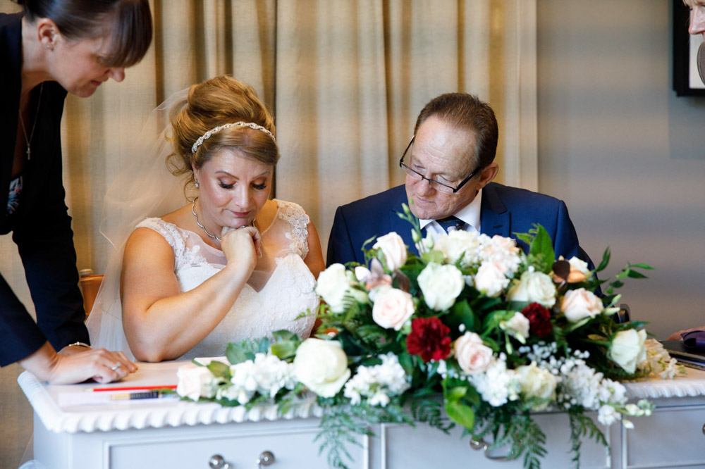 Gary signs the register with a quiet smile