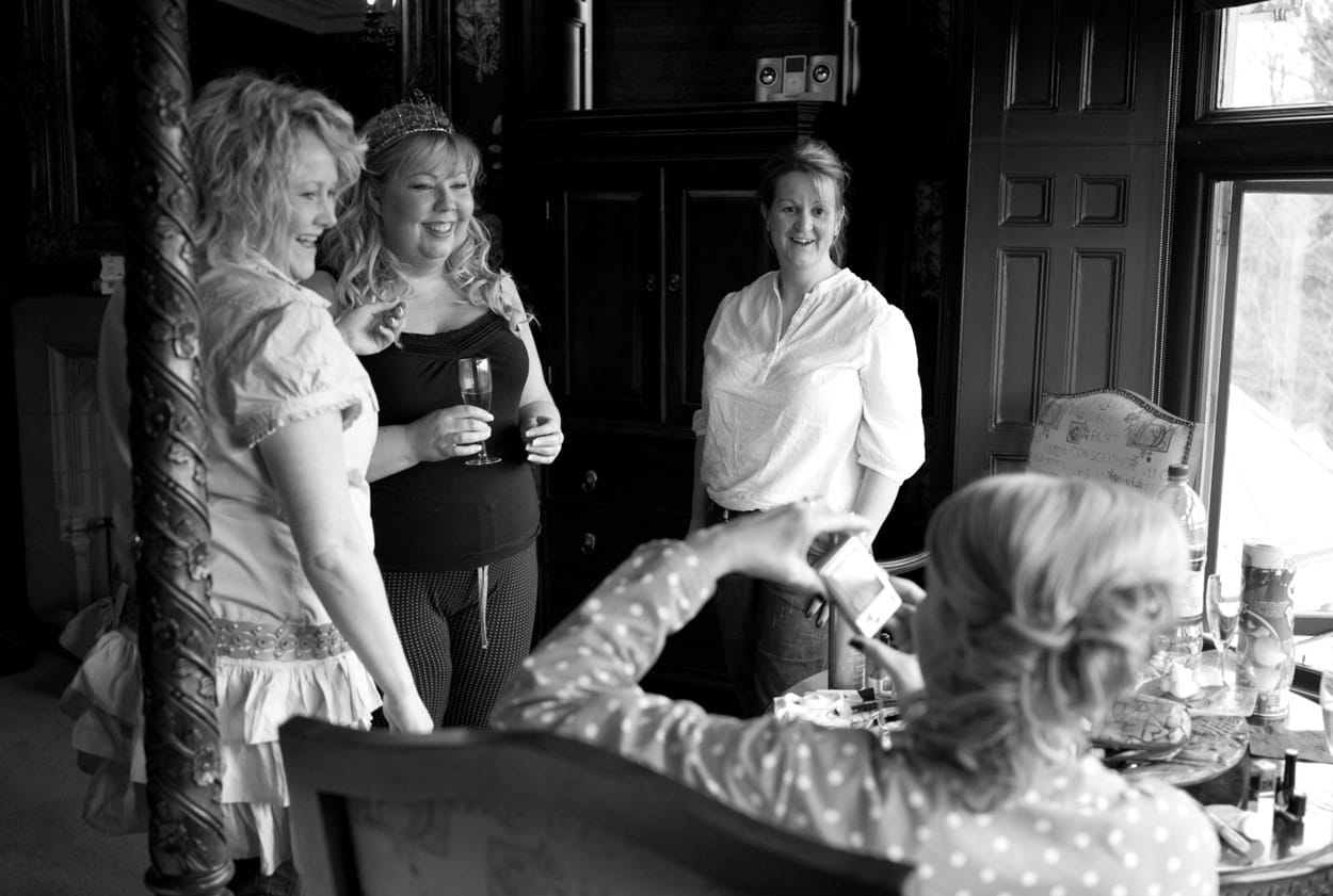 Nikki and two bridesmaids sharing a candid moment, photographed by another guest.
