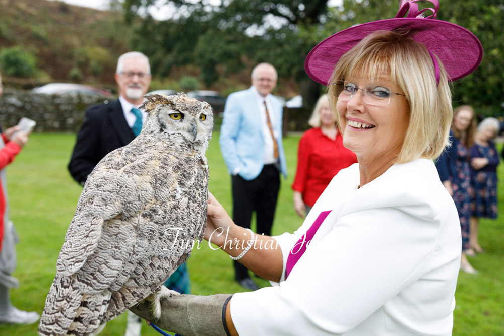 Candid wedding moment with bride's mother and owl at Barden Tower