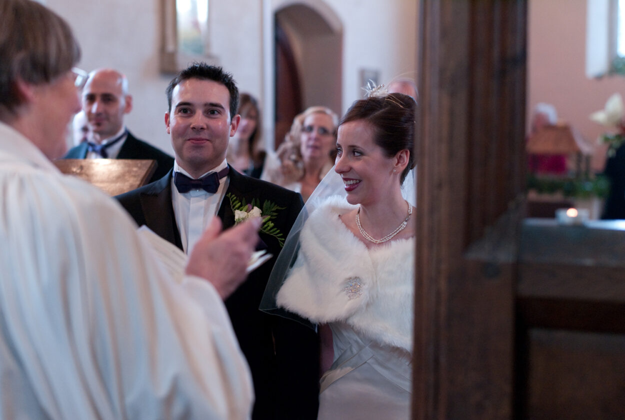 The couple smiling as the ceremony begins, captured in the relaxed style I use for Leeds weddings.