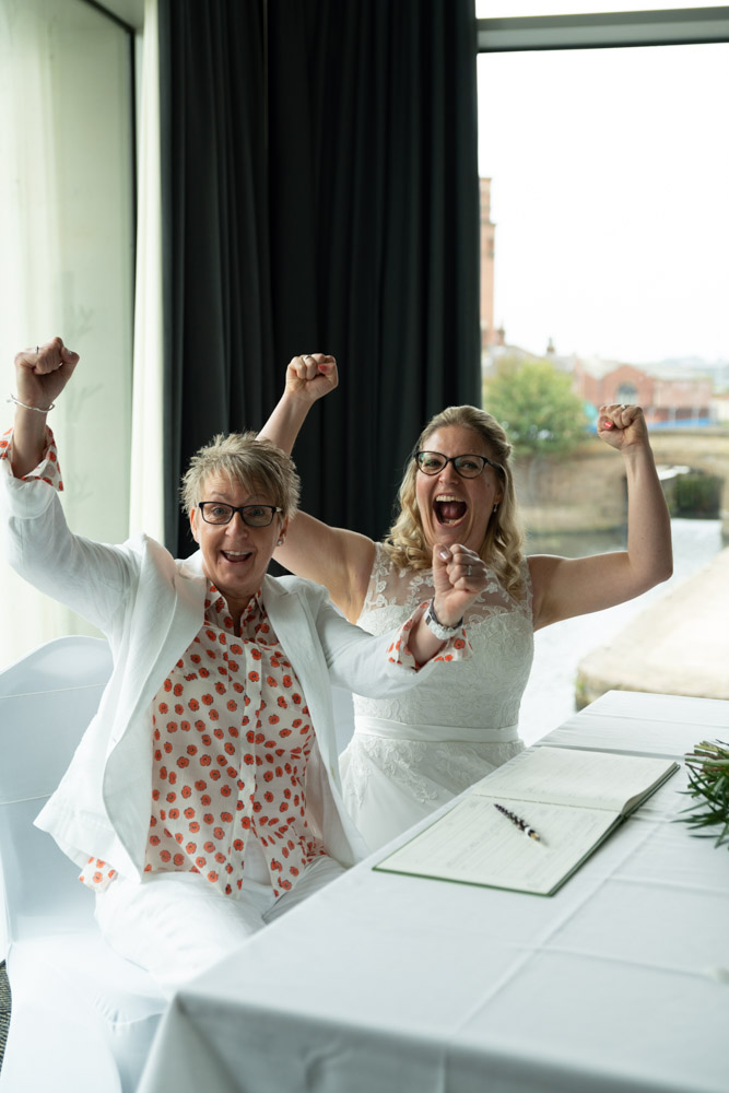 The couple cheer with raised arms at DoubleTree by Hilton Leeds