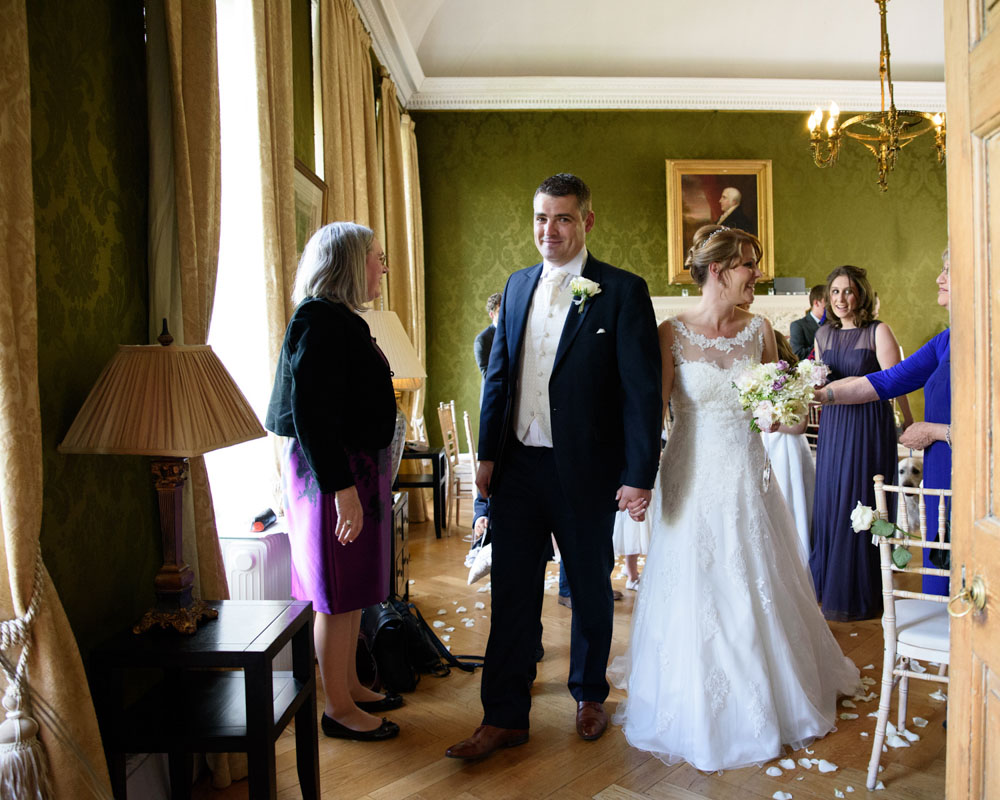 Couple smiles as they reach the doors of the ceremony room at Grays Court.
