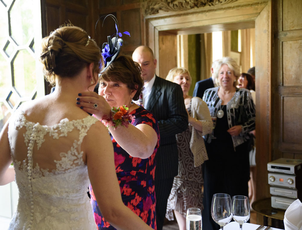 Bride warmly welcomes important guests as they exit the ceremony.