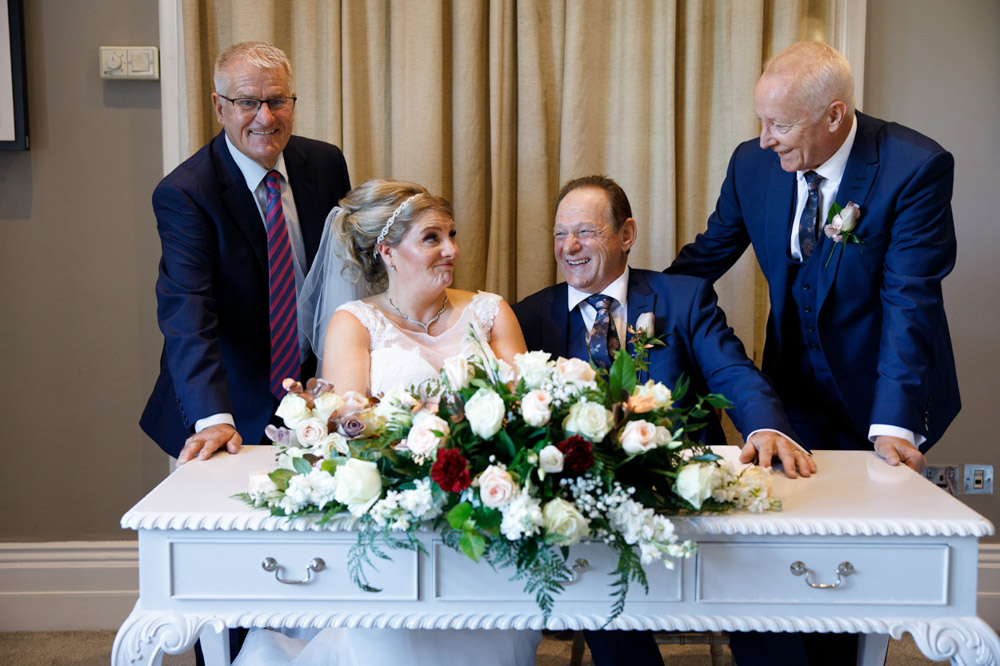 Photo with the witnesses smiling and chatting after the ceremony