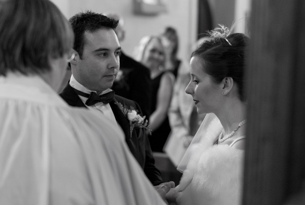 Groom looks lovingly toward his bride.