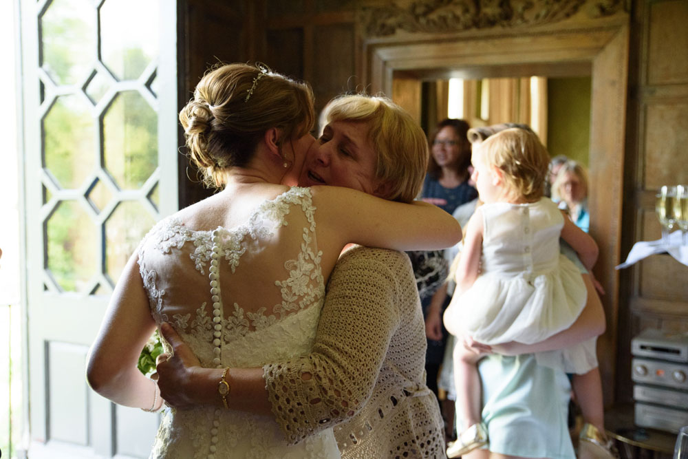 Lisa hugs family warmly as guests exit the ceremony.