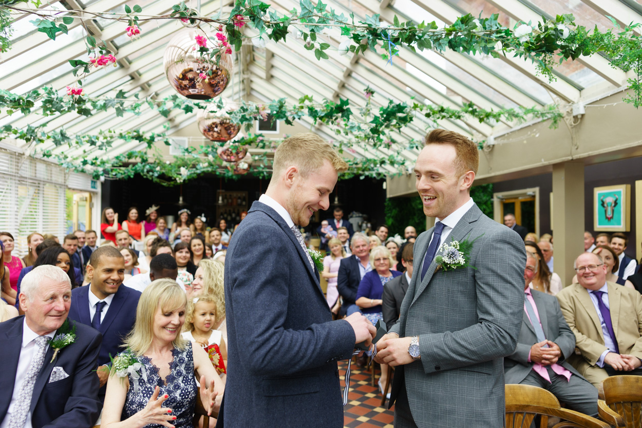 Christian placing the wedding ring on Jason’s hand