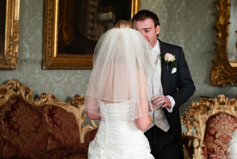 The newlyweds share a quiet word during the register signing.