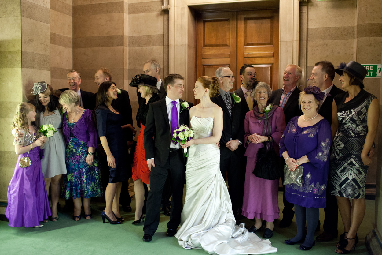 Natural group of friends laughing together inside Leeds Civic Hall.