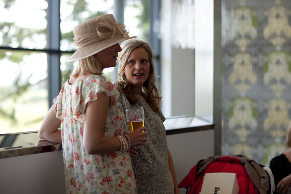 Female guests indoors, relaxed in soft natural light.