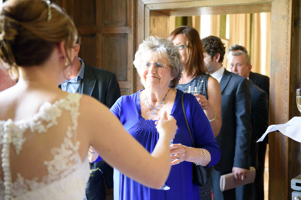 Happy guests exchanging hellos and hugs as they leave the ceremony.