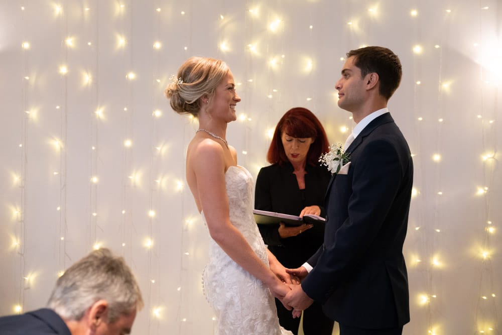 Bride and groom read vows during their wedding ceremony at the Chilli Barn, Otley.