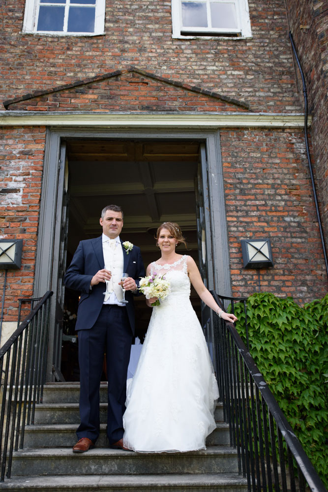 The couple walk midway down steps leading into the gardens at Grays Court.