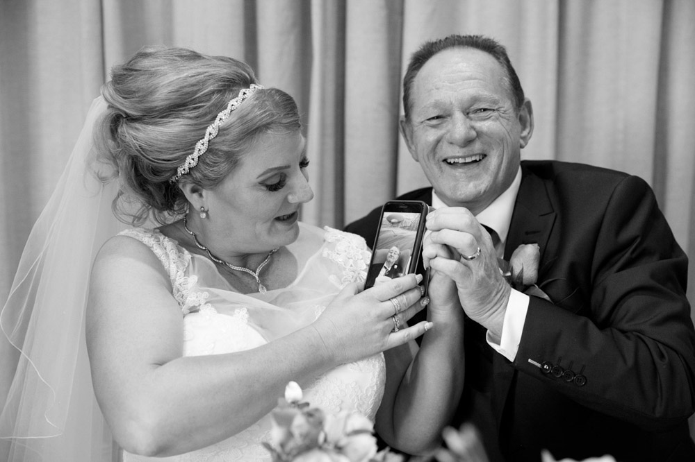 Same scene in black and white as Tracy chats with her relative via phone