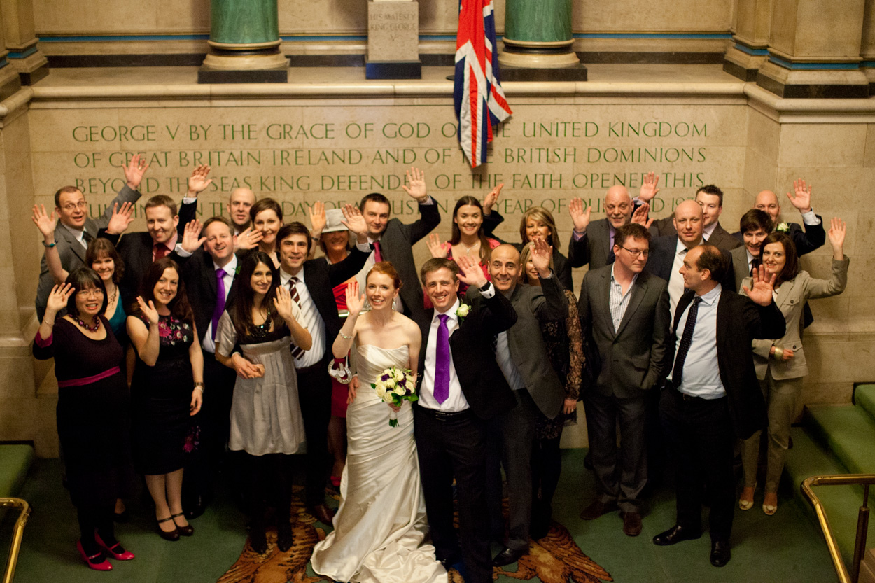 Overhead view of guests waving up toward the camera inside Leeds Civic Hall.