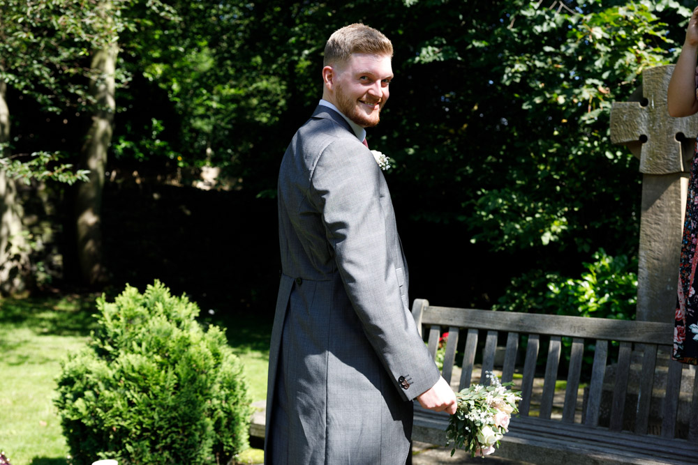 Matt playfully holds a smaller bouquet before tossing it for the single gents to catch.