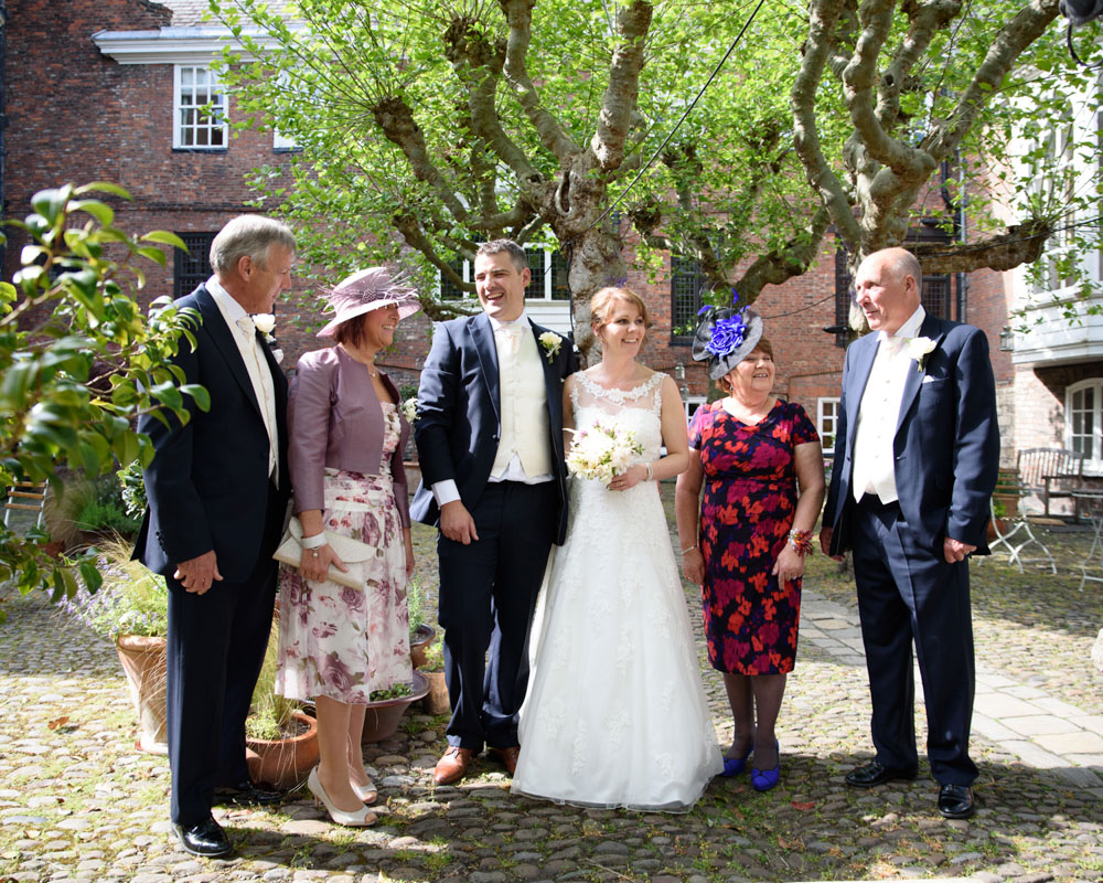 Parents pose for a photo on the cobbled stones outside the rear entrance of Grays Court.
