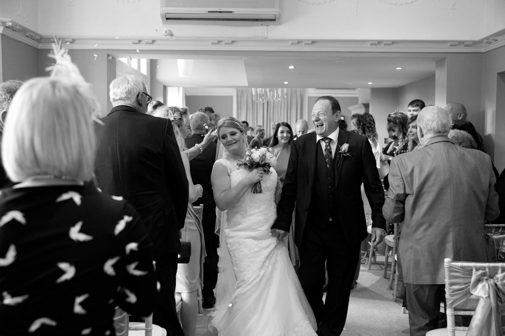 Couple laughing and joking with friends during their exit