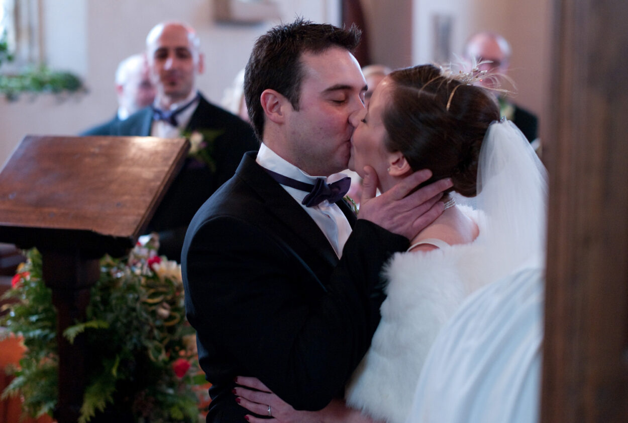 The kiss continues in a warm embrace.