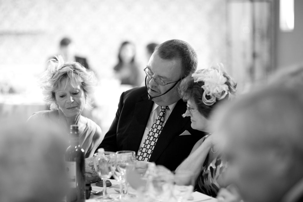 Black and white photo of guests seated and chatting.