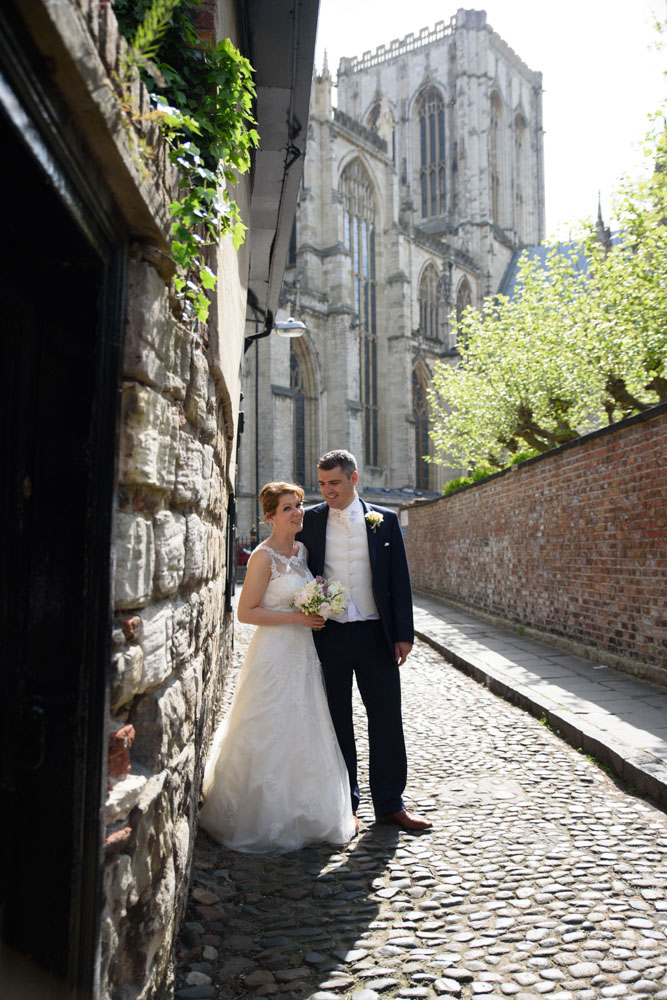 The couple on the cobbled road near Grays Court with the minster in the background.