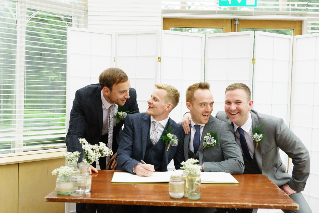 Wedding signing table photo with laughter between the group
