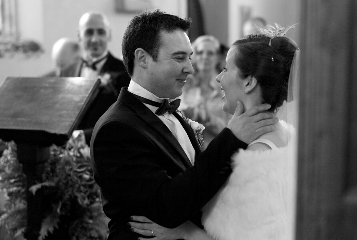 The couple laugh quietly with emotion after the kiss.