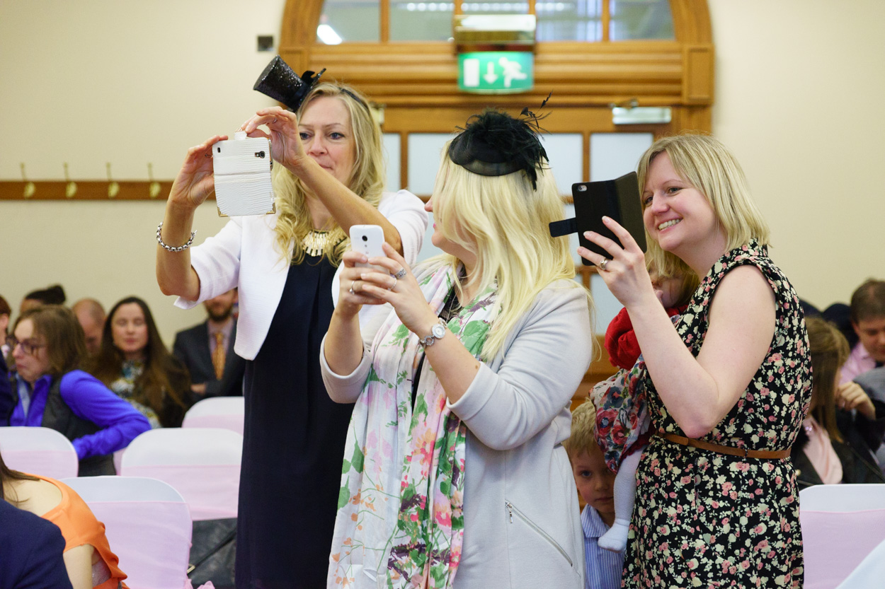 Guests stepping forward to photograph the couple