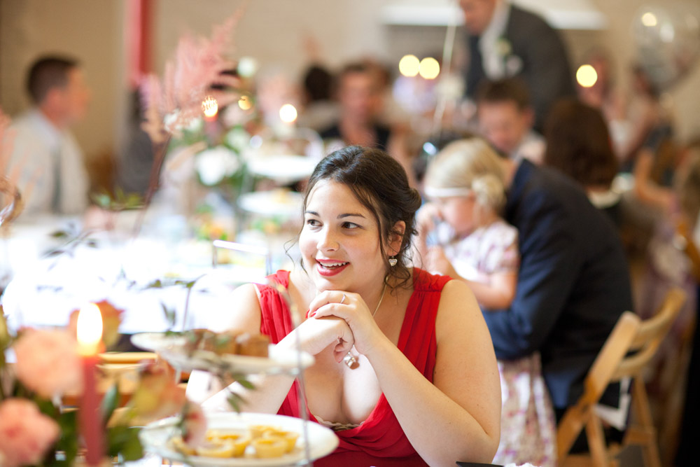 Best man and his girlfriend smiling together at the wedding reception