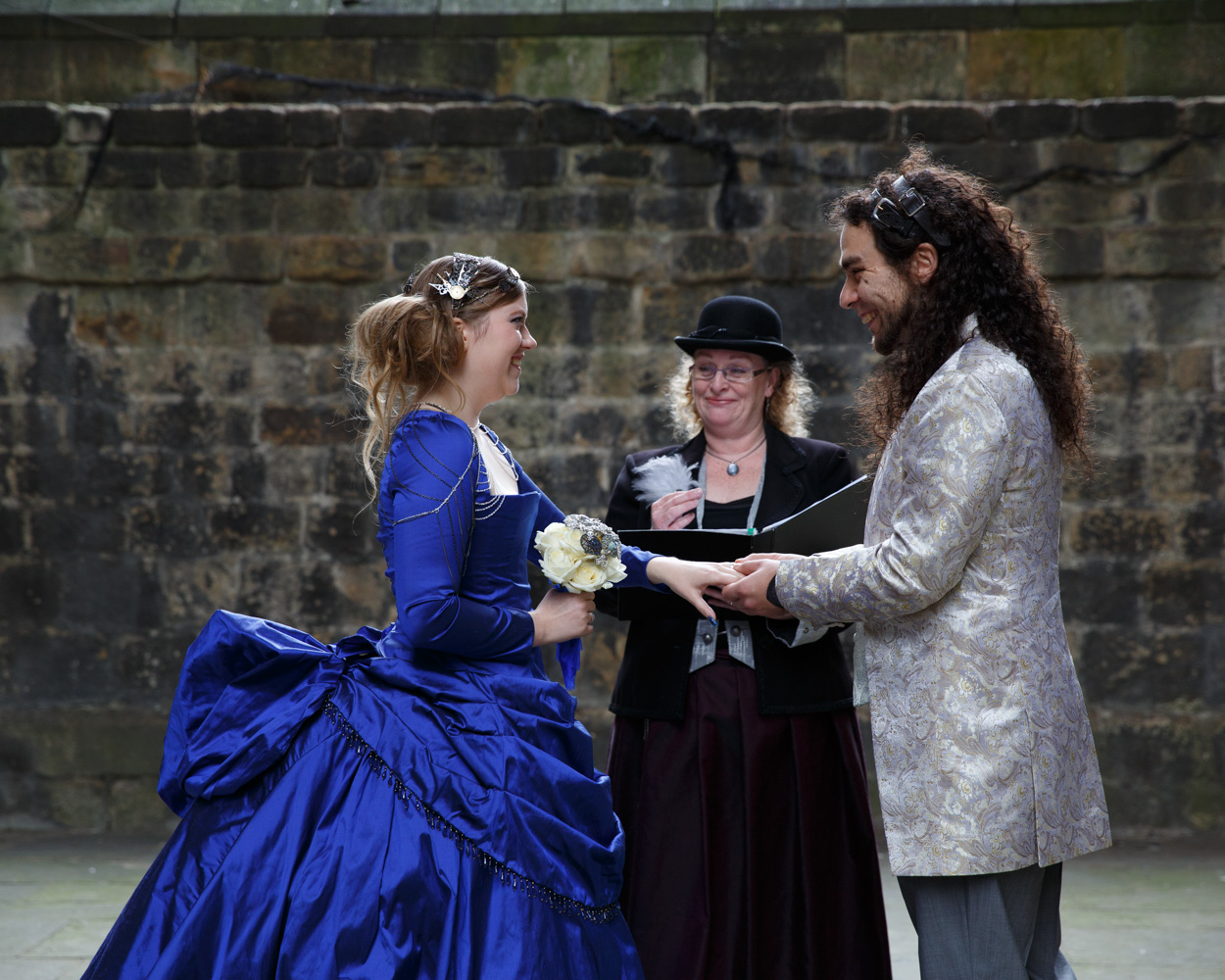 The groom places the ring on the bride’s finger, joy clear on both faces