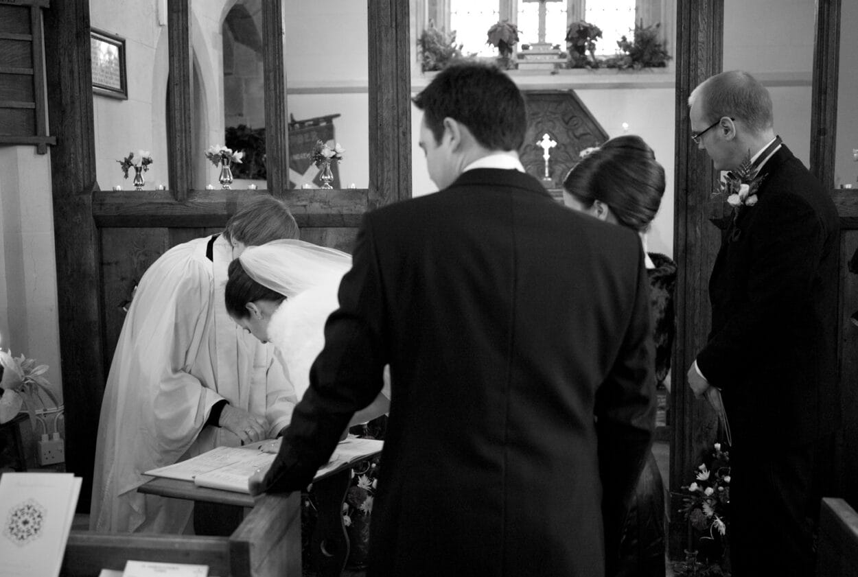 Emelie leans in to sign the register.