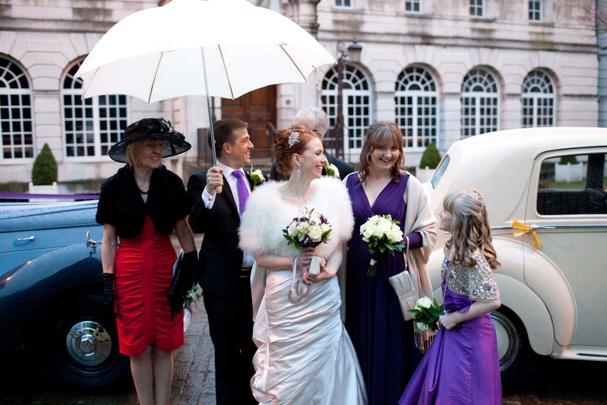 Close-up of the couple reacting to the rain, laughing together.