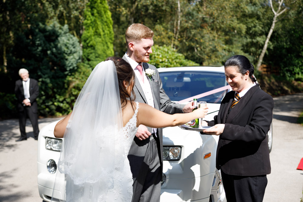 The couple arrive at Chevin Country Park Hotel & Spa and are welcomed with champagne by the entrance.